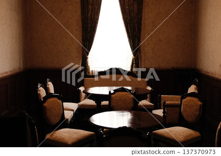 A study in a Western-style building with a Taisho-era romantic atmosphere. A desk with a black telephone and old ledgers. A study in a Western-style building with a Taisho-era romantic atmosphere. A desk with a black telephone and old ledgers. 137370973