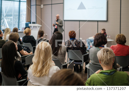 Business workshop presentation with speaker and attentive audience in modern conference room Business workshop presentation with speaker and attentive audience in modern conference room 137371207