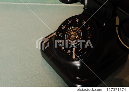 Retro rotary dial phone. Vintage telephone with beautiful gold decoration. Retro rotary dial phone. Vintage telephone with beautiful gold decoration. 137371874