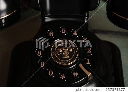 Retro rotary dial phone. Vintage telephone with beautiful gold decoration. Retro rotary dial phone. Vintage telephone with beautiful gold decoration. 137371877