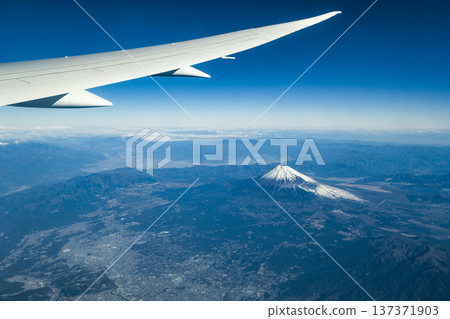Snow-capped Mount Fuji and the Southern Alps seen from the plane window Snow-capped Mount Fuji and the Southern Alps seen from the plane window 137371903