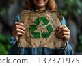 Hands Holding Worn Paper With Recycling Symbol 137371975