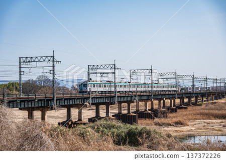 Kyoto Municipal Subway train crossing the Kintetsu Kyoto Line railway bridge over the Kizu River, Joyo City, Kyoto Prefecture, Kyotanabe City Kyoto Municipal Subway train crossing the Kintetsu Kyoto Line railway bridge over the Kizu River, Joyo City, Kyoto Prefecture, Kyotanabe City 137372226