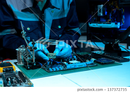 Macro photo of a finger touching a laptop chip close up Macro photo of a finger touching a laptop chip close up 137372735