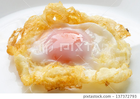 Fried egg on white dish close up Fried egg on white dish close up 137372793