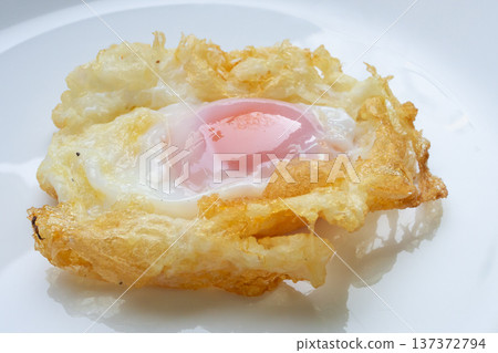Fried egg on white dish close up 137372794