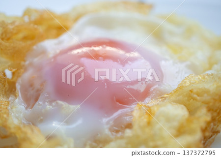 Fried egg on white dish close up 137372795