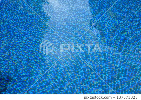 Swimming pool water surface and ripple wave with blue mosaic tiles Swimming pool water surface and ripple wave with blue mosaic tiles 137373323
