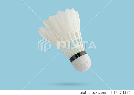 Badminton shuttlecock floating on blue background 137373335
