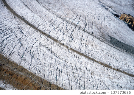 Pers Glacier in the Bernina Range captures the beauty of the Alps with its intricate ice formations and rugged mountain backdrop. 137373686