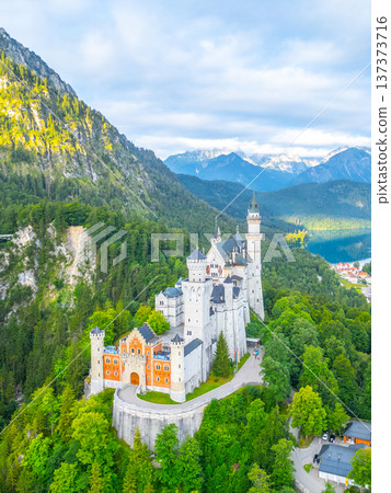 Nestled in the Bavarian mountains, Neuschwanstein Castle stands majestically surrounded by lush greenery. Nestled in the Bavarian mountains, Neuschwanstein Castle stands majestically surrounded by lush greenery. 137373716