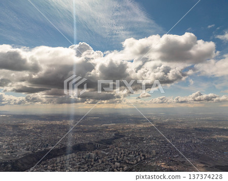Cityscape from above with dynamic cloud formations and natural light Cityscape from above with dynamic cloud formations and natural light 137374228