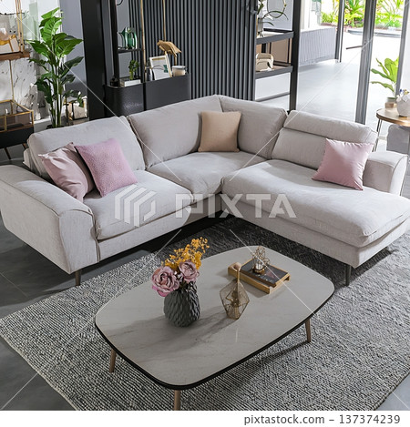 White sectional sofa with pink pillows 137374239