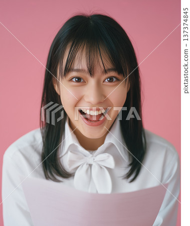 Young woman looking at acceptance notice paper, surprised smile, upper body photo Young woman looking at acceptance notice paper, surprised smile, upper body photo 137374845