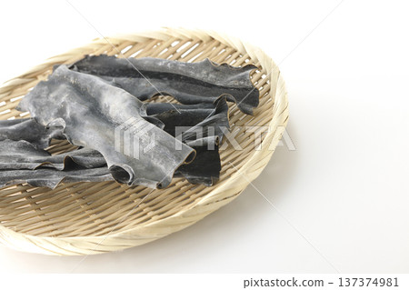 Dried kelp on a basket photographed against a white background Dried kelp on a basket photographed against a white background 137374981