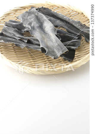 Dried kelp on a basket photographed against a white background 137374990