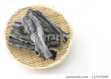 Dried kelp on a basket photographed against a white background Dried kelp on a basket photographed against a white background 137374994