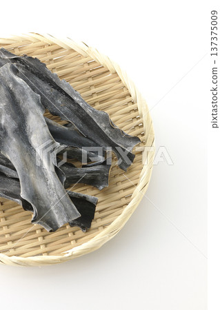 Dried kelp on a basket photographed against a white background 137375009