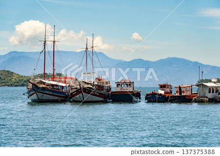 Fishing vessels moored side by side in the harbour in Angra dos Reis, Brazil 137375388