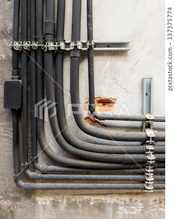 Industrial Electrical Conduits and PVC Pipes on Hospital Wall. Industrial Electrical Conduits and PVC Pipes on Hospital Wall. 137375774