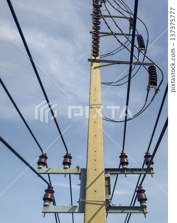 High Voltage Electric Concrete Pole with Insulators in Suburb. High Voltage Electric Concrete Pole with Insulators in Suburb. 137375777