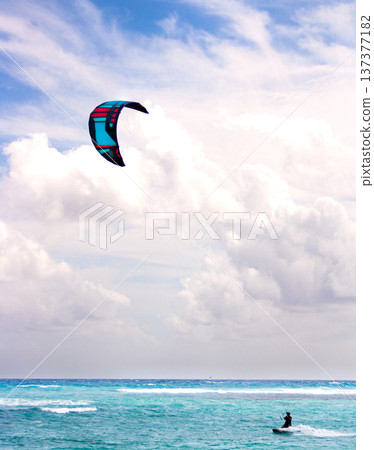 Young man kitesurfing in the blue waters of the caribbean sea 137377182