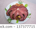 Octopus dish presentation of grilled octopus with vegetables and lemon on plate 137377715