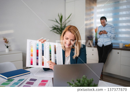 Woman presenting color swatches during online design meeting 137377870