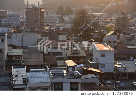 Takayama City, Gifu Prefecture, Japan - The three-story pagoda of Hida Kokubunji Temple, the surrounding townscape, and a beautiful sunset during the Takayama Spring Festival 137378076