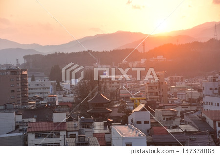 Takayama City, Gifu Prefecture, Japan - The three-story pagoda of Hida Kokubunji Temple, the surrounding townscape, and a beautiful sunset during the Takayama Spring Festival 137378083