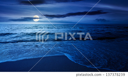 sandy sea beach background on cold summer night. low angle view. full moon over empty seascape scenery with calm waves. beauty seashore wallpaper. mysterious bay photo for advertising sandy sea beach background on cold summer night. low angle view. full moon over empty seascape scenery with calm waves. beauty seashore wallpaper. mysterious bay photo for advertising 137378239