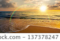 sunset over sandy sea beach background in autumn. low angle view. empty seascape scenery with calm waves. beauty seashore wallpaper. peaceful bay photo for advertising. weather with rainbow 137378247