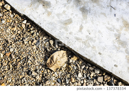 Concrete And Gravel Surfaces, A striking textured photo of concrete and gravel surfaces capturing raw urban material beauty, suitable for construction, background and industrial documentary. Concrete And Gravel Surfaces, A striking textured photo of concrete and gravel surfaces capturing raw urban material beauty, suitable for construction, background and industrial documentary. 137378334