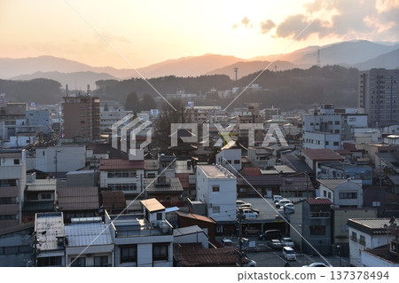 Takayama City, Gifu Prefecture, Japan - The townscape of the three-story pagoda in the city center and a beautiful sunset during the Takayama Spring Festival Takayama City, Gifu Prefecture, Japan - The townscape of the three-story pagoda in the city center and a beautiful sunset during the Takayama Spring Festival 137378494