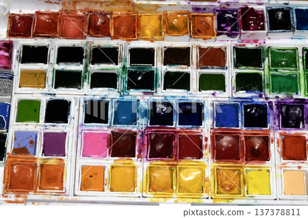 A Colourful Watercolour Painters Pallet of Messy Used Half Pan Paints Creative Background A Colourful Watercolour Painters Pallet of Messy Used Half Pan Paints Creative Background 137378811