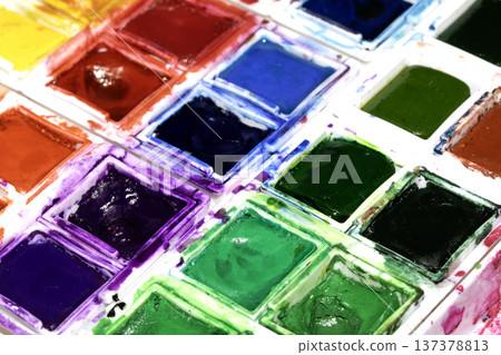 A Colourful Watercolour Painters Pallet of Messy Used Half Pan Paints Creative Background A Colourful Watercolour Painters Pallet of Messy Used Half Pan Paints Creative Background 137378813
