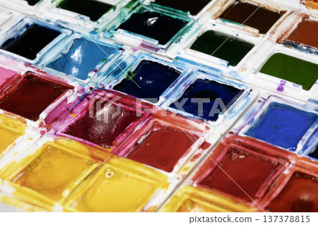 A Colourful Watercolour Painters Pallet of Messy Used Half Pan Paints Creative Background A Colourful Watercolour Painters Pallet of Messy Used Half Pan Paints Creative Background 137378815