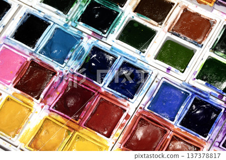 A Colourful Watercolour Painters Pallet of Messy Used Half Pan Paints Creative Background A Colourful Watercolour Painters Pallet of Messy Used Half Pan Paints Creative Background 137378817