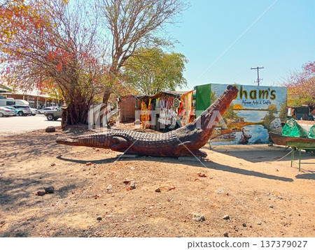 Souvenir shop and giant crocodile carving in Chobe town, Botswana Souvenir shop and giant crocodile carving in Chobe town, Botswana 137379027