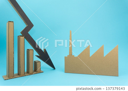 Chart showing a decline in production with factory and graph made from cardboard on a blue background 137379143