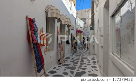 Cobblestone narrow shopping street surrounded by white buildings 137379438