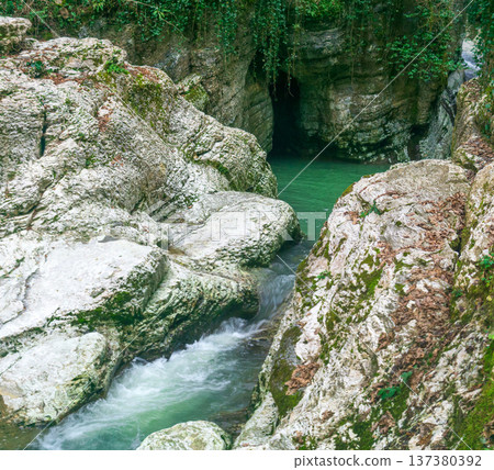 Mountain river flowing through the rocks. Landscape with a mountain river. Mountain river flowing through the rocks. Landscape with a mountain river. 137380392
