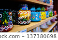 Colorful Hand Painted Ceramic Cups on Wooden Shelf 137380698