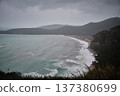 Dramatic Coastal Bay with Waves and Mountainous Shoreline 137380699