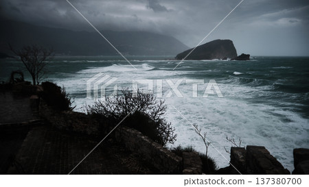 Stormy Sea with Waves Crashing Toward Rocky Island 137380700