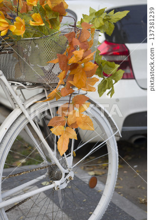 The bike is decorated with yellow autumn leaves. The bike is decorated with yellow autumn leaves. 137381239