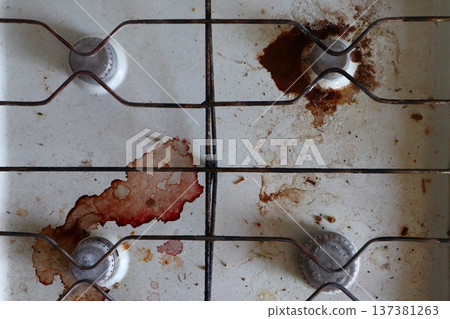 Top view of a very dirty white gas stove. 137381263