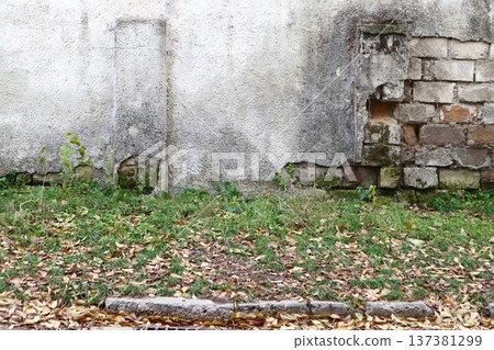 An old stone wall with sprinkled plaster. An old stone wall with sprinkled plaster. 137381299