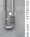 The pipe with a valve on the outside wall. 137381300