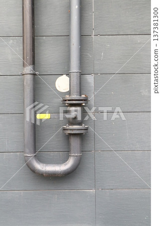 The pipe with a valve on the outside wall. The pipe with a valve on the outside wall. 137381300
